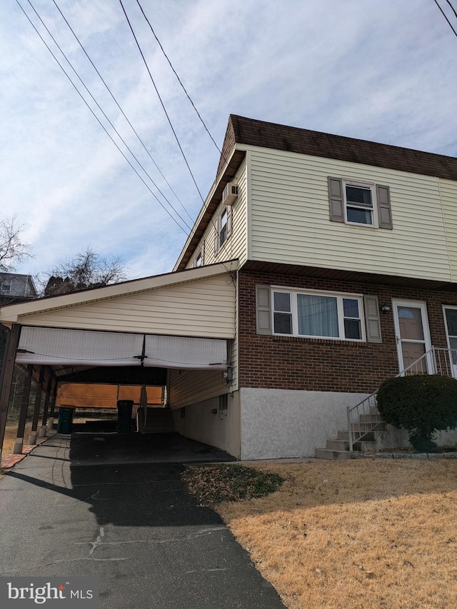 view of front of property featuring brick siding and driveway