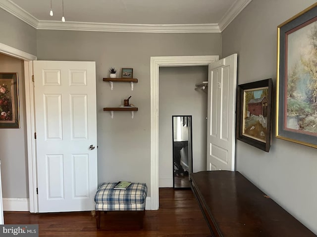 corridor featuring ornamental molding, baseboards, and wood finished floors