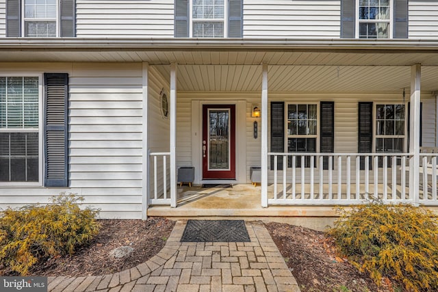 view of exterior entry featuring a porch