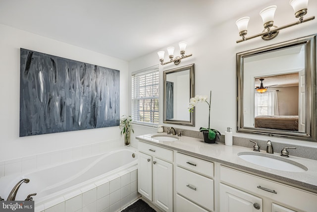 full bath with double vanity, a sink, and a bath