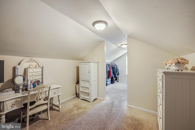 home office featuring lofted ceiling, light colored carpet, and baseboards