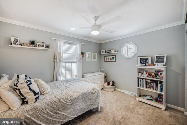 carpeted bedroom with baseboards, a ceiling fan, visible vents, and crown molding