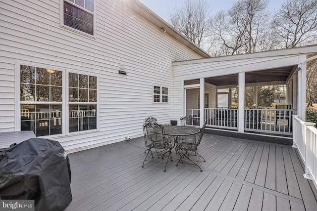 wooden deck featuring outdoor dining area and area for grilling