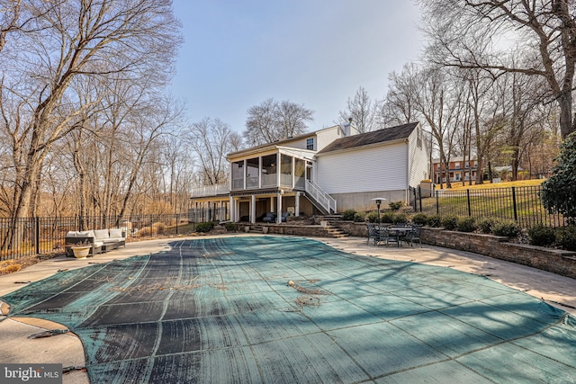 view of swimming pool with a fenced in pool, stairway, a sunroom, a patio area, and fence