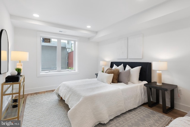 bedroom with visible vents, baseboards, wood finished floors, and recessed lighting