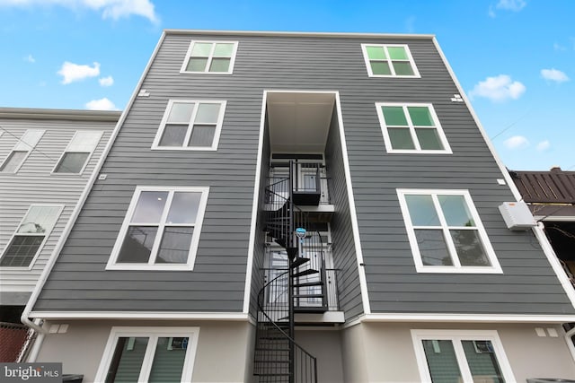 exterior space featuring stairway and stucco siding