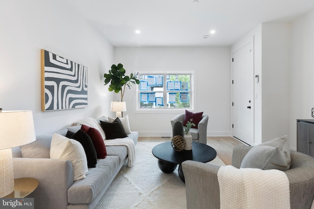 living area with recessed lighting, baseboards, and light wood finished floors