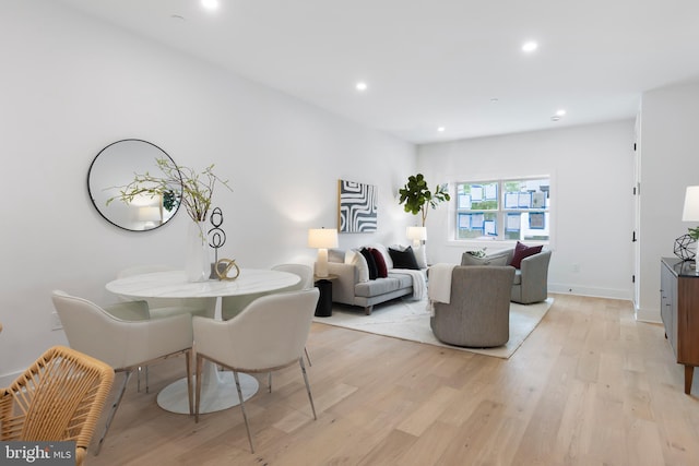 living room with light wood finished floors, baseboards, and recessed lighting