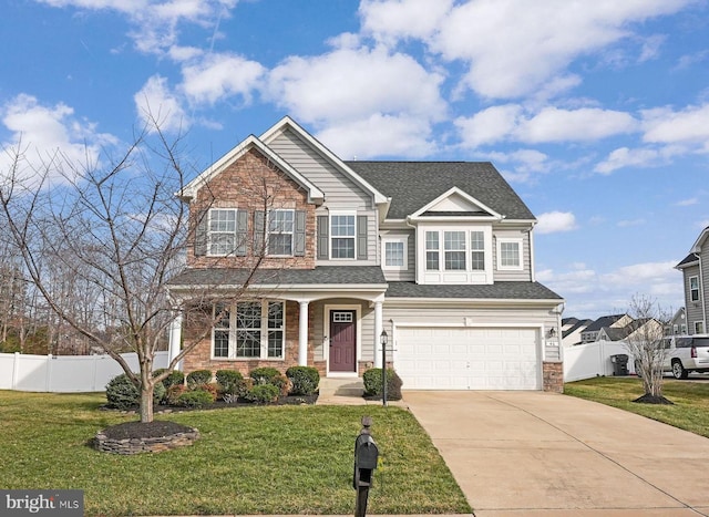 view of front of home with a garage, concrete driveway, a front yard, and fence