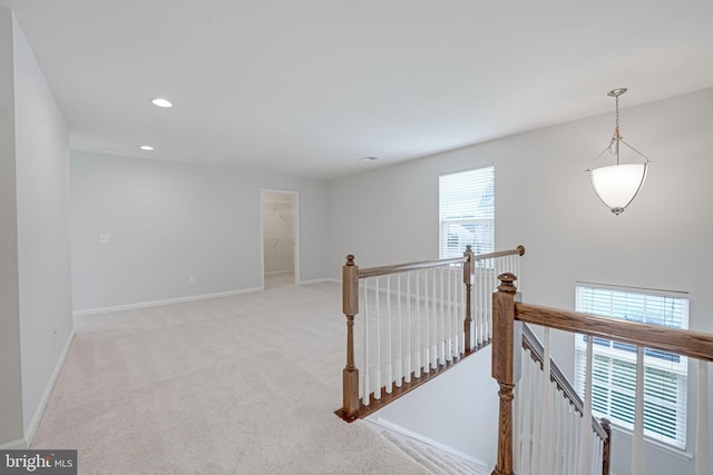 hallway featuring recessed lighting, an upstairs landing, baseboards, and carpet floors