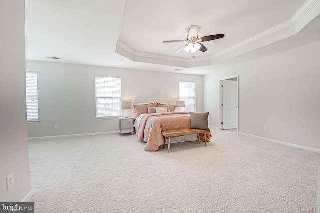 bedroom with visible vents, crown molding, baseboards, carpet, and a tray ceiling