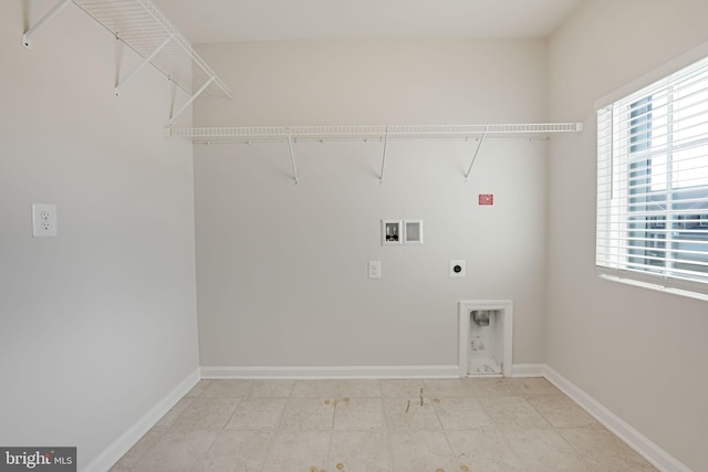 washroom featuring laundry area, hookup for a washing machine, hookup for an electric dryer, and baseboards