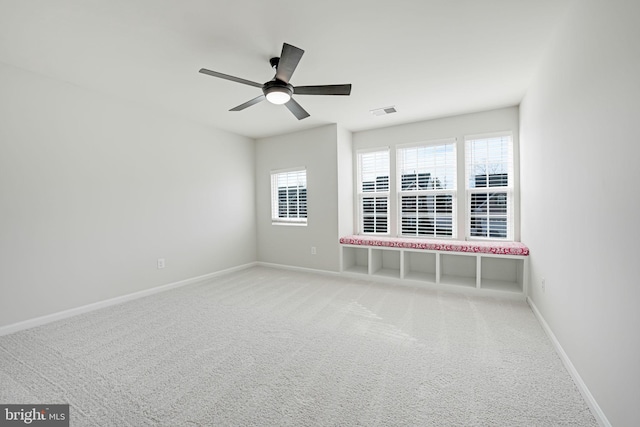 empty room with visible vents, ceiling fan, baseboards, and carpet floors