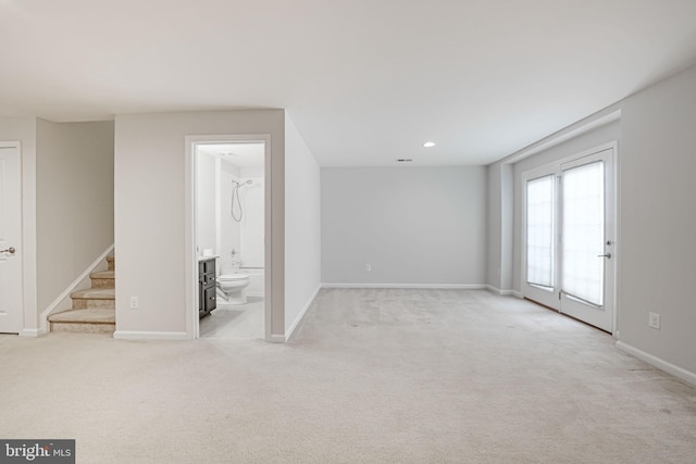 interior space featuring recessed lighting, baseboards, light colored carpet, and stairs