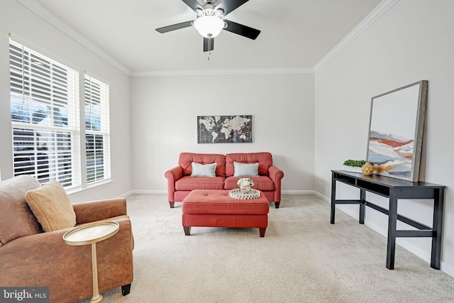 carpeted living room featuring ceiling fan, baseboards, and ornamental molding