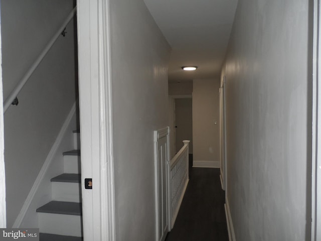 hall featuring stairs and baseboards