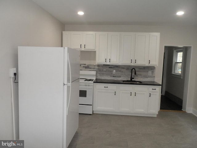 kitchen with tasteful backsplash, white appliances, white cabinetry, and a sink