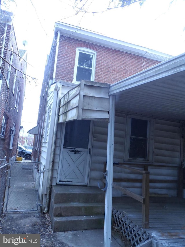 doorway to property featuring brick siding