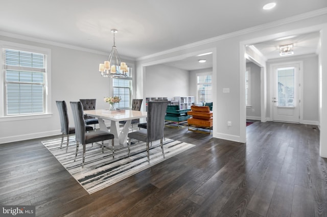 dining area featuring dark wood-type flooring, ornamental molding, and baseboards