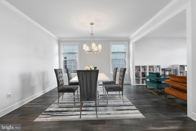 dining area with a chandelier, crown molding, baseboards, and wood finished floors