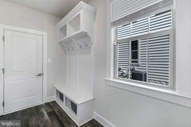 mudroom with dark wood-style flooring and baseboards