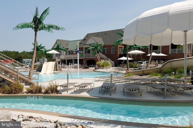 community pool featuring stairway and a patio