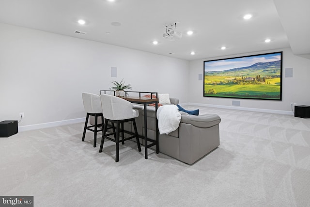 home theater room featuring baseboards, recessed lighting, visible vents, and light colored carpet