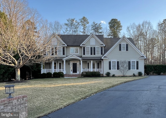 traditional home featuring a front lawn and a porch