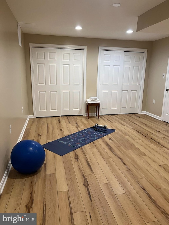 workout room featuring baseboards and hardwood / wood-style flooring