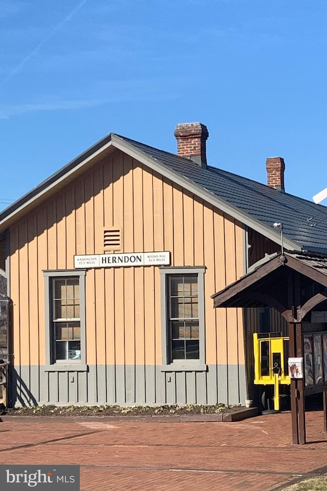 view of side of property featuring a chimney and board and batten siding