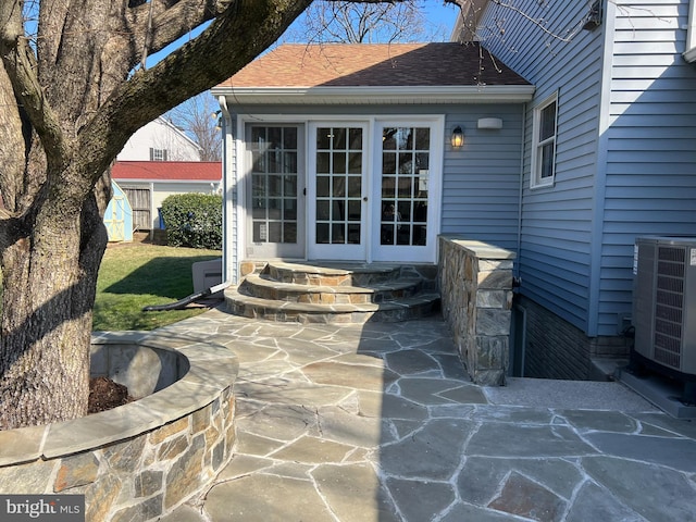 view of patio featuring entry steps, cooling unit, and french doors