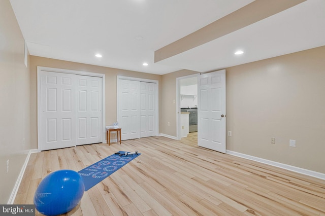 exercise area with baseboards, wood finished floors, and recessed lighting