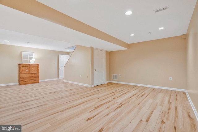 finished basement featuring recessed lighting, light wood-type flooring, visible vents, and baseboards