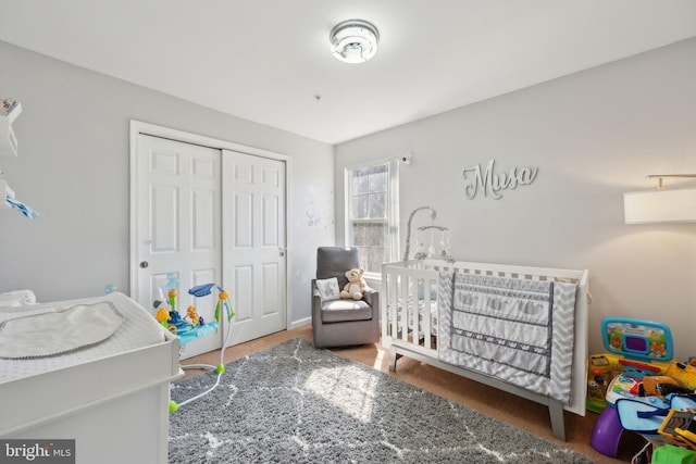 bedroom with a closet and a crib