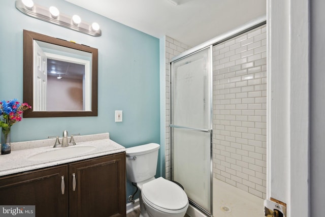 full bathroom with toilet, a shower stall, and vanity