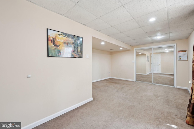 finished basement with recessed lighting, carpet flooring, a drop ceiling, and baseboards