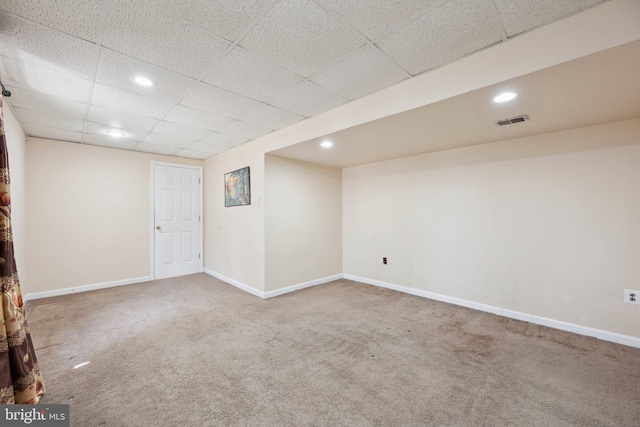 finished basement with baseboards, visible vents, a paneled ceiling, carpet floors, and recessed lighting