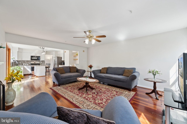 living area featuring ceiling fan and hardwood / wood-style floors