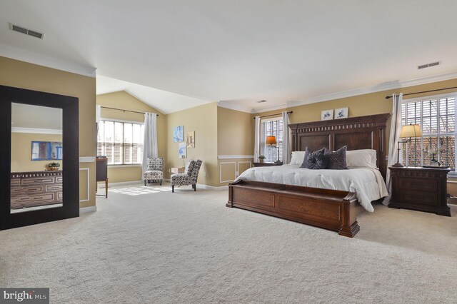 carpeted bedroom featuring visible vents, lofted ceiling, and ornamental molding