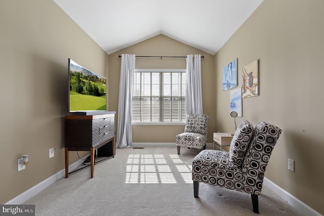 living area with baseboards, carpet, and lofted ceiling