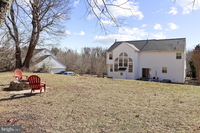 rear view of house with a yard and a sunroom