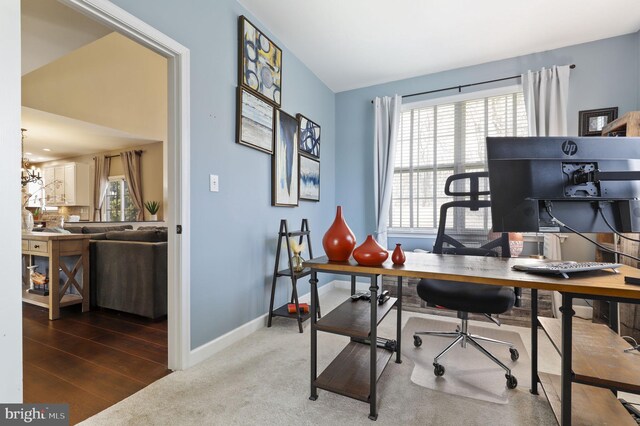 office space with baseboards, carpet floors, and a chandelier