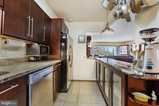 kitchen with baseboards, decorative light fixtures, wine cooler, light tile patterned floors, and appliances with stainless steel finishes