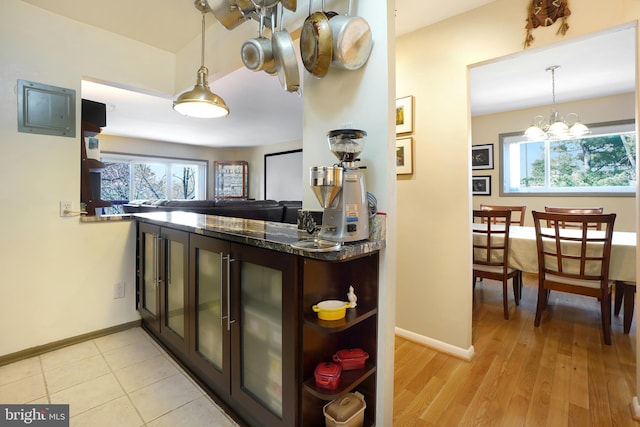 kitchen with dark brown cabinetry, plenty of natural light, and open shelves