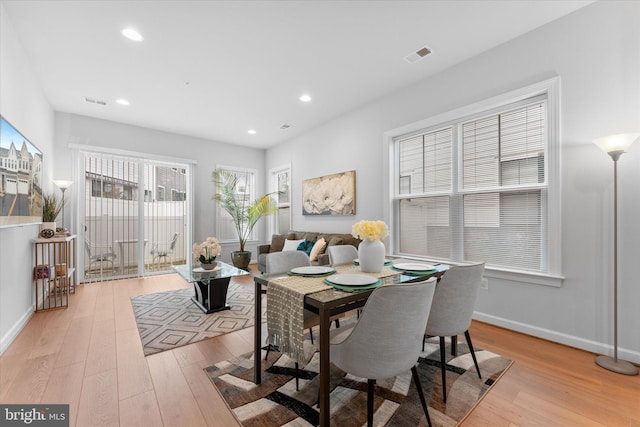 dining space with light wood-type flooring, visible vents, baseboards, and recessed lighting