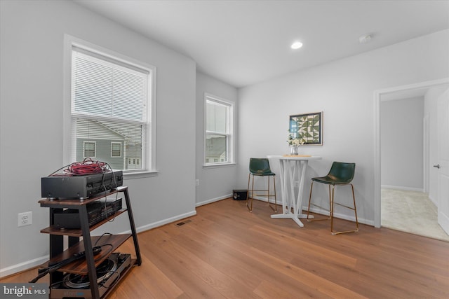 interior space featuring recessed lighting, wood finished floors, visible vents, and baseboards