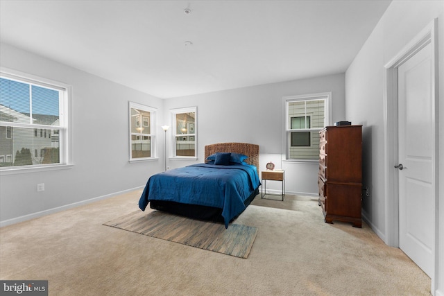 carpeted bedroom featuring baseboards