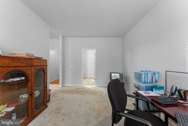 carpeted office space featuring baseboards