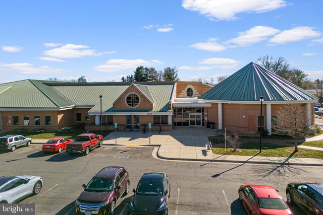 view of building exterior with uncovered parking