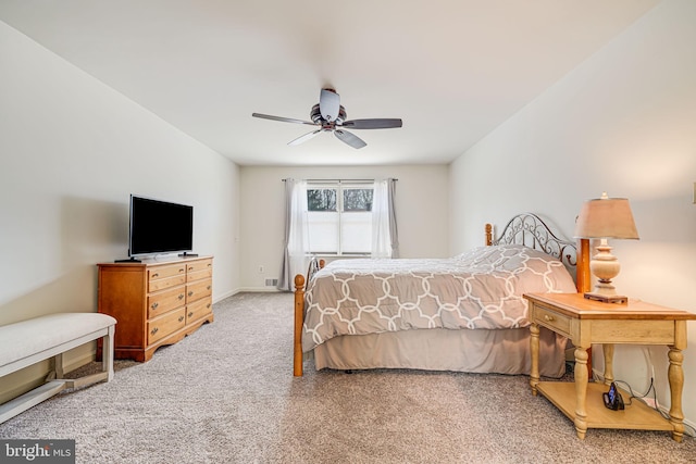 bedroom featuring ceiling fan, baseboards, and carpet